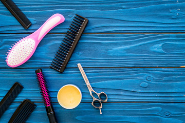 combs for hairdresser hairdresser on blue wooden background top view