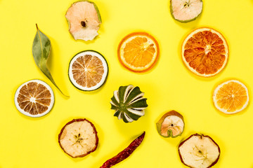 Colorful dried fruits isolated on yellow background