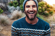 © Cavan Images - Portrait of cheerful hiker wearing warm clothing on field