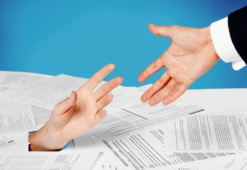 Wall Mural - Close up of businesswoman hand in stack of papers