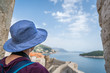 Woman in blue hat looking at Dubrovnik Old Town