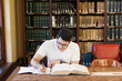 © Cavan Images - Young student studying in library