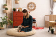 © New Africa - Young woman with cat in stylish room interior