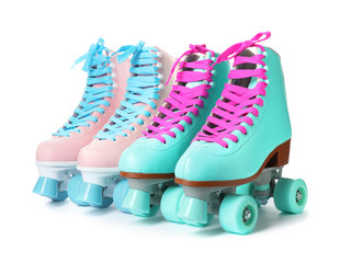 Wall Mural - pairs of bright stylish roller skates on white background