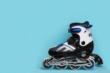 Wall Mural - pair of inline roller skates on color background. space for text