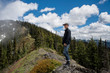 © Cavan Images - Side view of man looking away while standing on mountain against cloudy sky in Olympic National Park