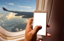 Hand Holding Mobile Phone With Blank Screen Neary Window Seat In Airplane