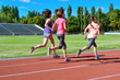 © Iuliia Sokolovska - Family sport and fitness, happy mother and kids running on stadium track outdoors, children healthy active lifestyle concept