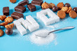Text No is lined with sugar cubes and sweets. Harm to the health of sweet and rejection of sucrose