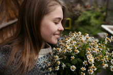 Smiling Young Woman Holding Bouquet