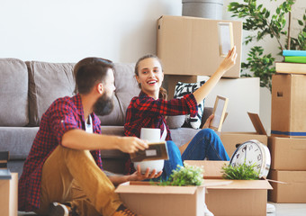 happy young married couple moves to new apartment