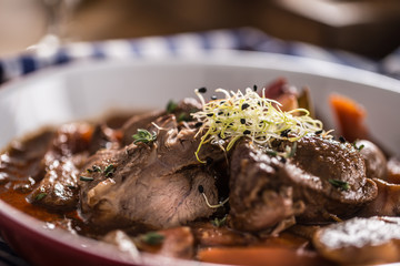 Roast wild boar with carrot mushrooms, baguette and draft beer