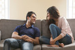 © IndiaPix - Young couple sitting on sofa at home