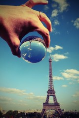 Wall Mural - hand of tourist with a big glass sphere in Paris