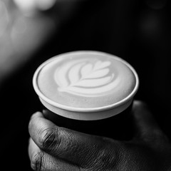 Wall Mural - African Coffee Barista holding a take away cup