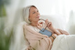 © goodluz - Beautiful senior woman relaxing in bed reading