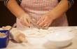 © lashkhidzetim - Woman kneading dough on table, closeup