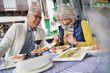 © goodluz - Attractive senior couple eating tapas outdoors