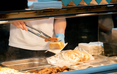 cook hands making a hot dog in fast food cafe f