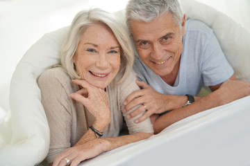 Wall Mural -  Portait of happy attractive senior couple in bed