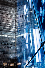 Skyscraper Modern LED Light And Glasswall Reflecting Another High Tower 