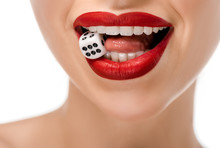 Close-up Partial View Of Young Woman Holding Dice In Teeth Isolated On White