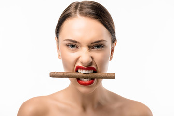 Wall Mural - beautiful naked girl holding cigar in teeth and looking at camera isolated on white