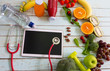 © SASITHORN - stethoscope and tablet  for planing Healthy eating with Workout and fitness dieting ,fitness and weight loss concept, fruit, Vegetable,top view on wooden background, Food and health