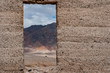 Looking out at mountain range through abandoned building in Death Valley national park