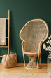 © Photographee.eu - Scandinavian ladder with blanket next to rattan peacock chair in elegant room with green wall and wooden screen and floor, real photo with copy space
