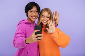 Wall Mural - Cheerful multhiethnic teenage couple