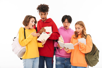 Wall Mural - Young group of friends students standing isolated over white wall background posing.