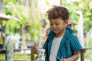 Wall Mural - Asian kids enjoying his painting with hands