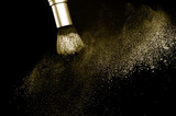 Fototapeta Panele - gold powder splash and brush for makeup artist or beauty blogger in black background, look like a luxury