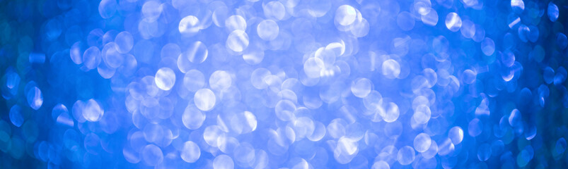 Bright  Abstract Blurred blue Background with Shimmering Glitter Holiday Bokeh. Christmas wallpaper decorations concept.Banner