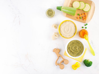 Top view of different types of vegetable puree on the light background