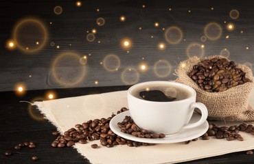 Canvas Print - Cup of hot coffee with beans, close up