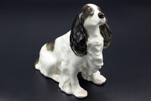 Antique Porcelain Figure Of A Dog Spaniel Breed On The Black Background
