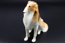 Antique Porcelain Figurine Of A Dog Collie Breed On The Black Background