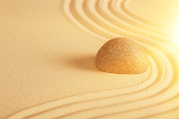 Poster - Zen stone in the sand on Background