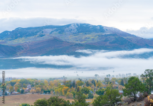 Fotografie, Obraz Low lying clouds over a small mountain town
