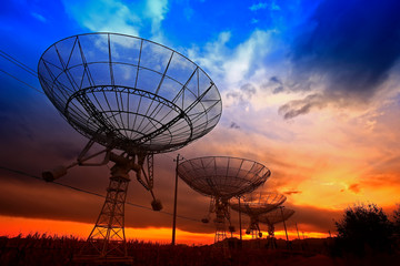 The silhouette of a radio telescope observatory