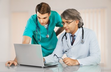 Sticker - Male doctor prescribing drugs to patient on background