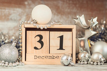 Hand Changing Wooden Calendar With Different New Year Decorations
