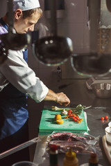 Wall Mural - Chef cutting fresh vegetables for salad