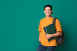 © Prostock-studio - Teen guy with books and backpack over background