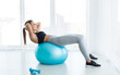 © Prostock-studio - Woman working out with fitness ball in gym