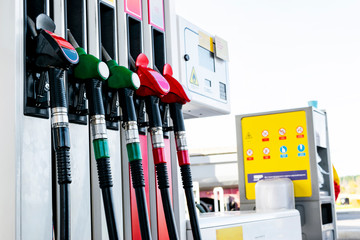 Gasoline and diesel distributor at the gas station. Gas pump nozzles. Petrol filling gun close-up at the gas station. Colorful Petrol pump filling nozzles. Fuel pump