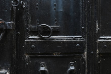 Closeup View Of Details Of Old Black Door. Horizontal Color Photography.