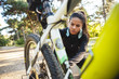 © Drobot Dean - Attractive fit sportswoman having to fix her bicycle at the park